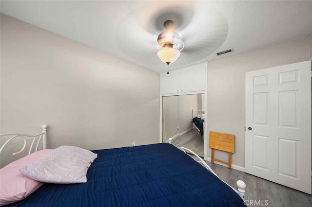 bedroom with ceiling fan, hardwood / wood-style floors, and a closet