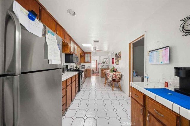 kitchen with appliances with stainless steel finishes and ceiling fan