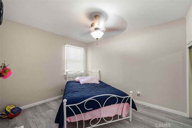 bedroom featuring wood-type flooring and ceiling fan