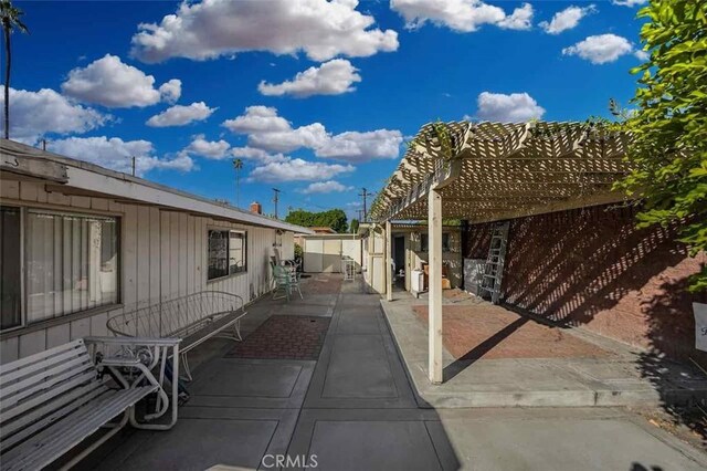 view of side of property with a pergola and a patio area