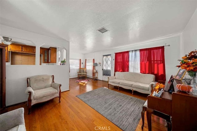 living room with hardwood / wood-style flooring and a textured ceiling