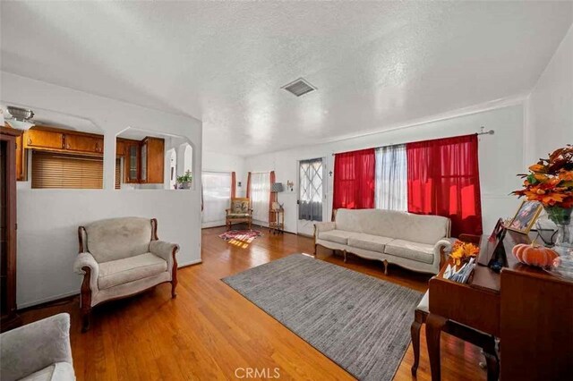 living room with hardwood / wood-style flooring and a textured ceiling