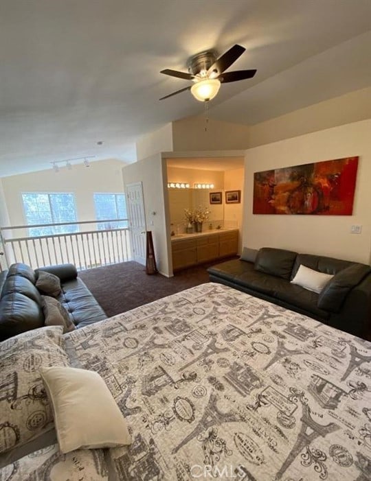 carpeted bedroom featuring ceiling fan and vaulted ceiling