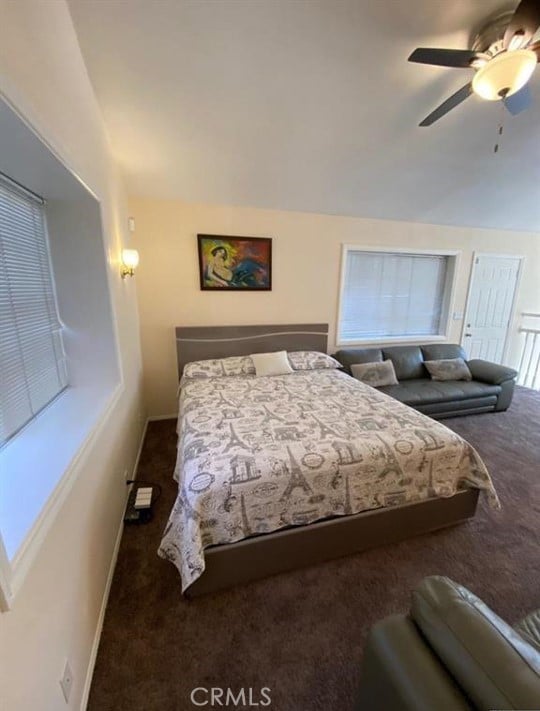 bedroom featuring ceiling fan and dark colored carpet