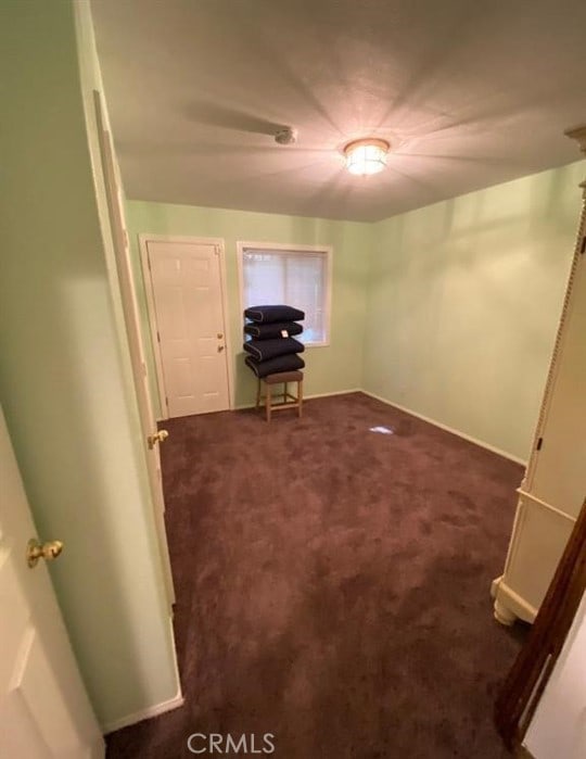 interior space with dark colored carpet