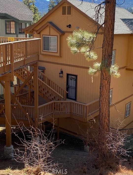 back of house featuring a wooden deck