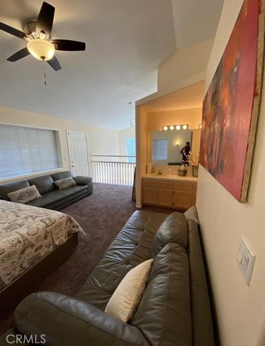 bedroom with ceiling fan, lofted ceiling, and carpet flooring