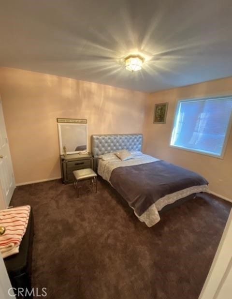 bedroom with dark colored carpet