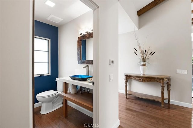 bathroom featuring sink, toilet, and hardwood / wood-style flooring