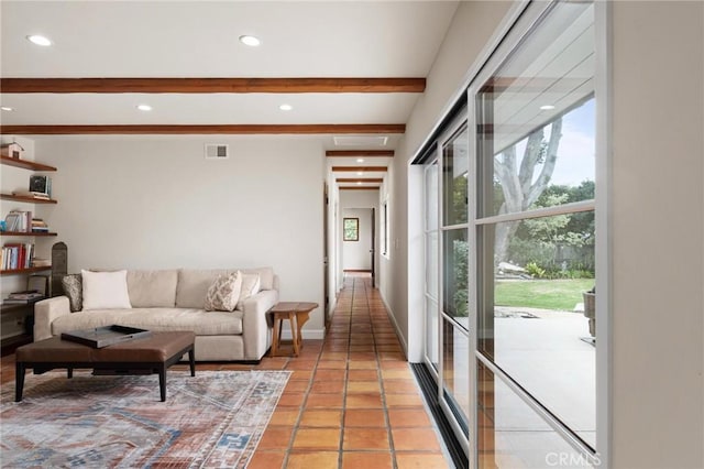 tiled living room featuring beamed ceiling