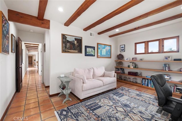 tiled home office featuring beamed ceiling