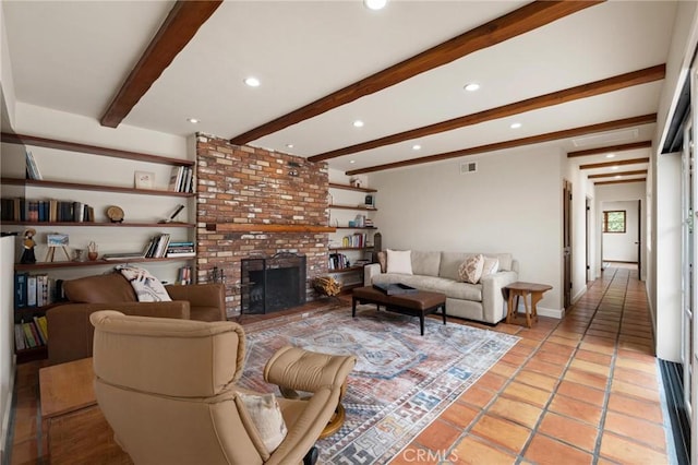 living room with beam ceiling, light tile patterned floors, and a fireplace