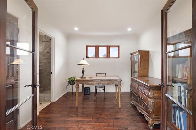 office with dark hardwood / wood-style flooring and french doors