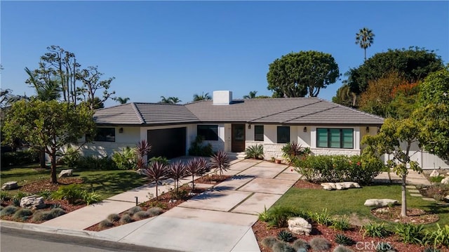 single story home featuring a front lawn and a garage