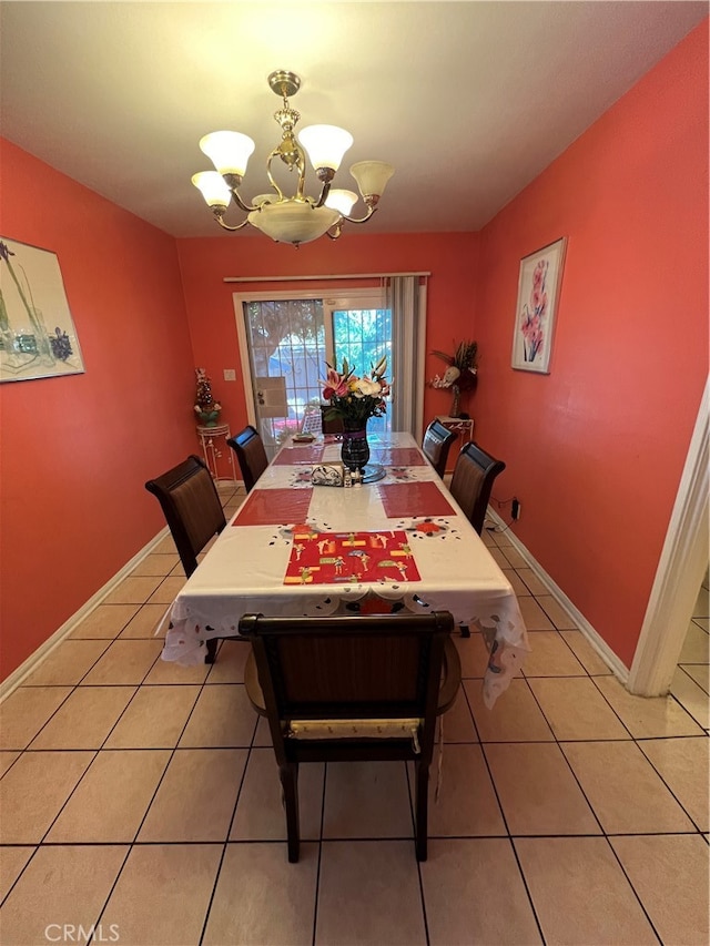 tiled dining area featuring a notable chandelier