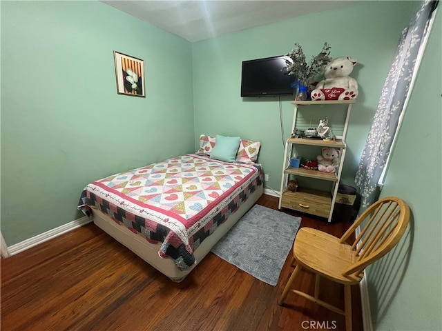 bedroom featuring dark hardwood / wood-style flooring