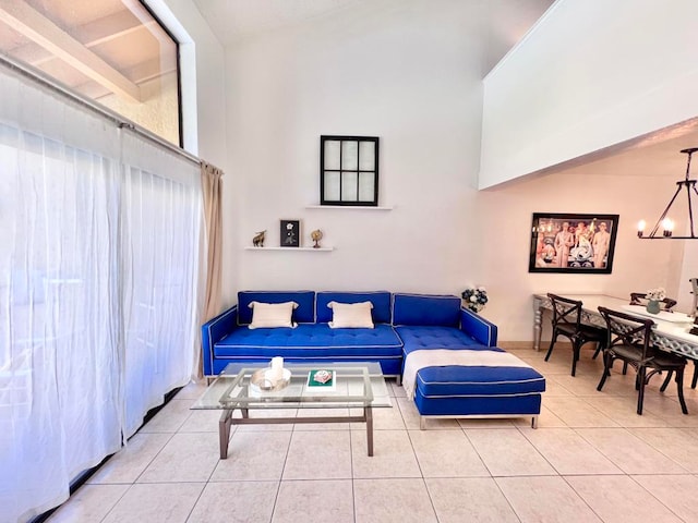 living room with tile patterned floors and an inviting chandelier