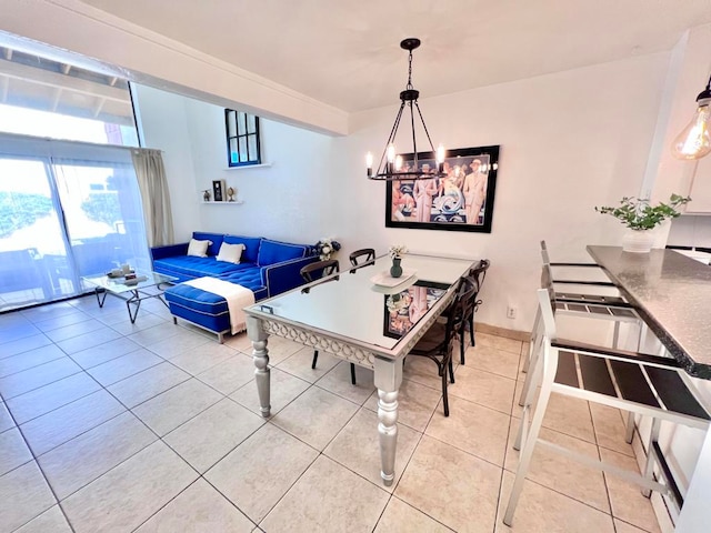 dining area featuring tile patterned floors and a chandelier