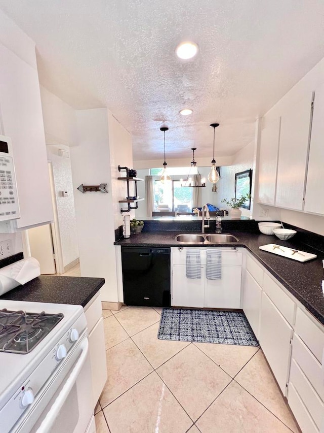 kitchen featuring pendant lighting, sink, dishwasher, white gas stove, and white cabinetry