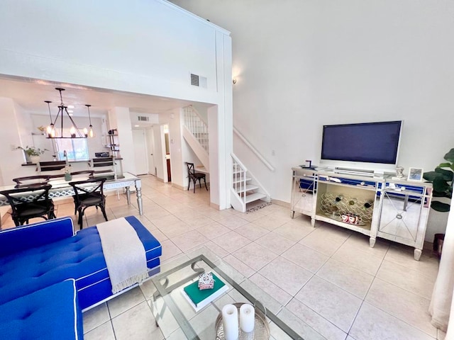 living room featuring tile patterned flooring and an inviting chandelier