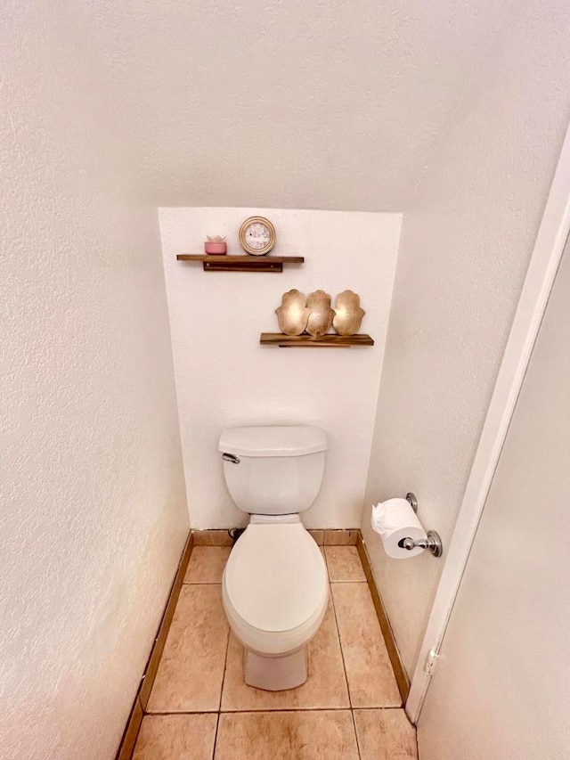 bathroom with tile patterned floors and toilet