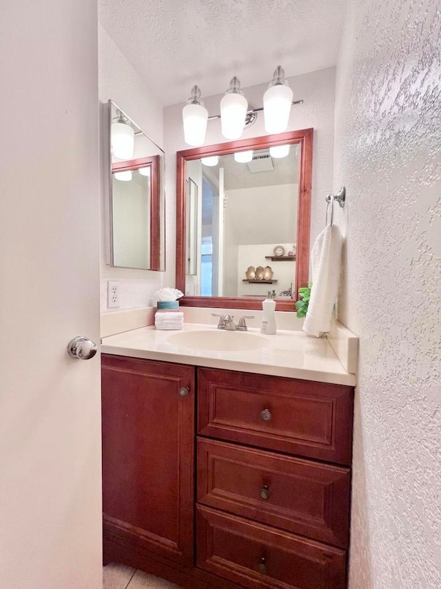 bathroom featuring vanity and a textured ceiling