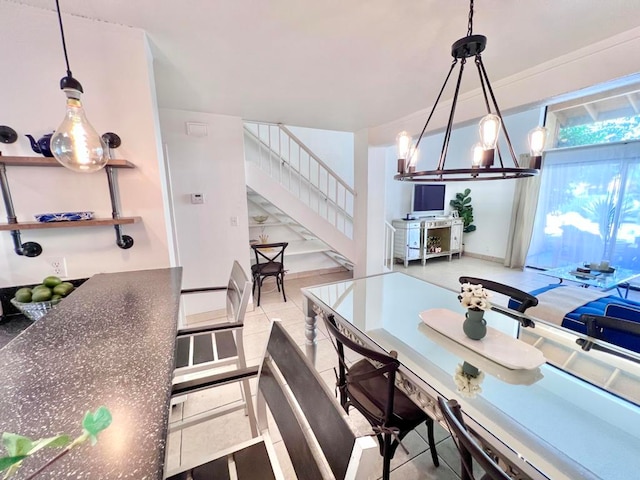 dining area featuring light tile patterned floors and a chandelier