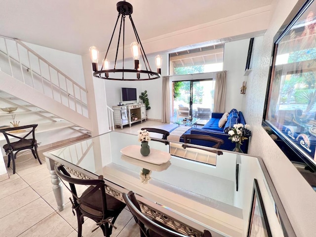 tiled dining room with an inviting chandelier