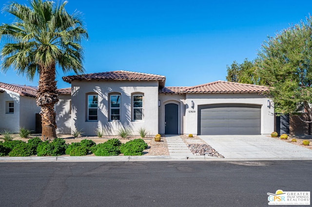 mediterranean / spanish house featuring a garage