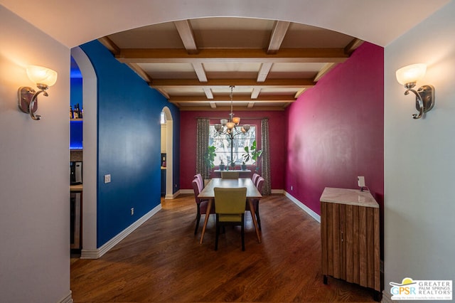 dining space with dark hardwood / wood-style floors, beam ceiling, and a chandelier