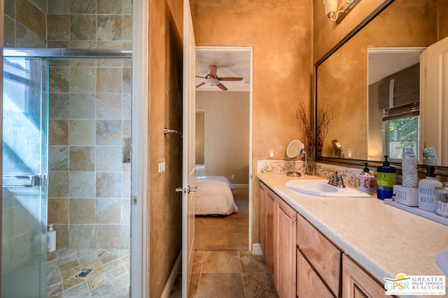 bathroom with ceiling fan, vanity, and an enclosed shower