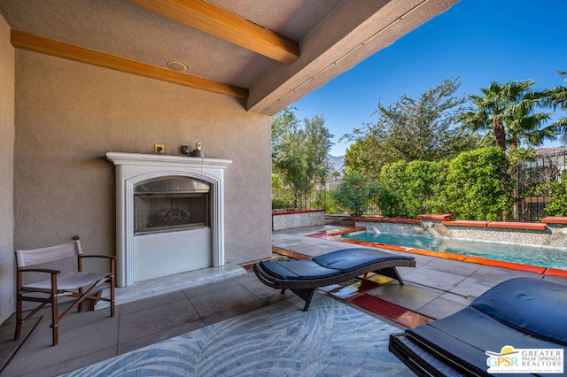 view of patio featuring pool water feature, a grill, and an outdoor fireplace