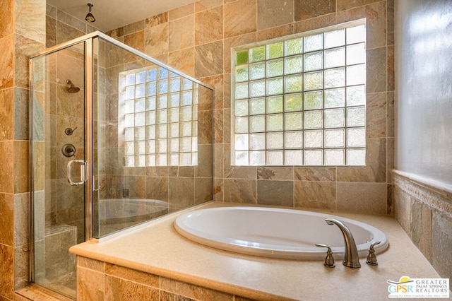 bathroom with separate shower and tub