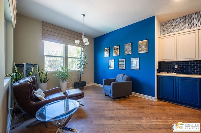 sitting room featuring light hardwood / wood-style flooring and a notable chandelier