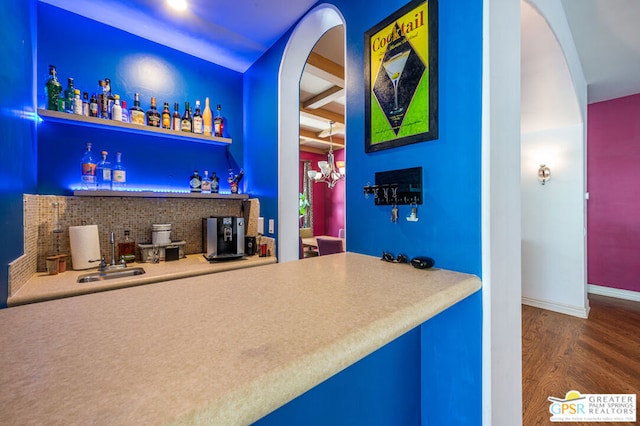 bar with beamed ceiling and dark hardwood / wood-style flooring