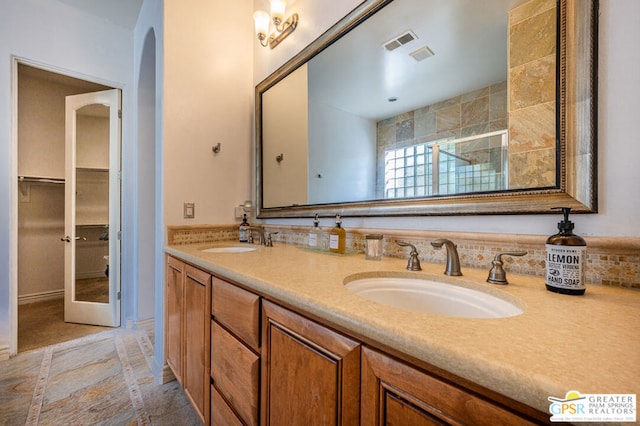 bathroom with vanity and a shower with door