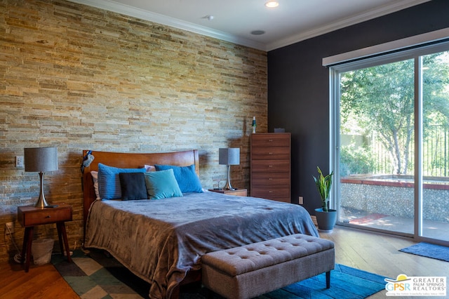 bedroom with wood-type flooring, crown molding, and access to outside