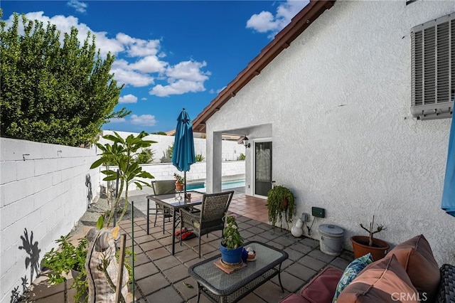 view of patio with a fenced in pool