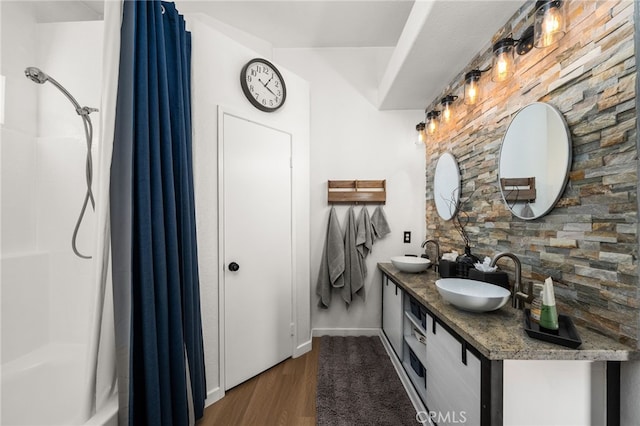 bathroom featuring walk in shower, vanity, and hardwood / wood-style floors