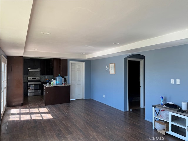 living room with a raised ceiling and dark hardwood / wood-style flooring