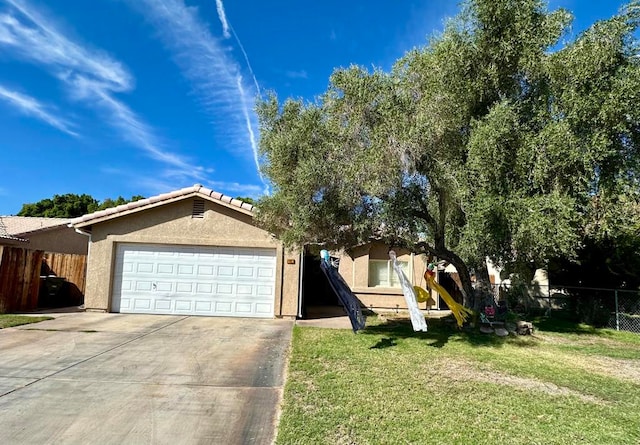 view of front of house featuring a garage and a front lawn