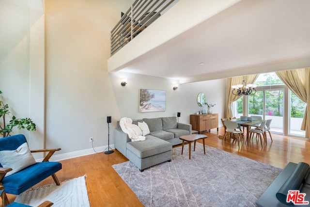 living room featuring light hardwood / wood-style floors and a chandelier