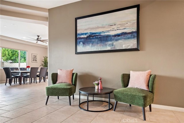 living area featuring ceiling fan and light tile patterned floors