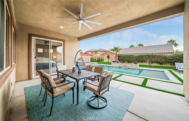 view of patio featuring ceiling fan and a fenced in pool