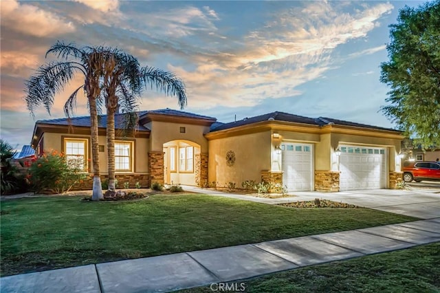 view of front facade featuring a lawn and a garage