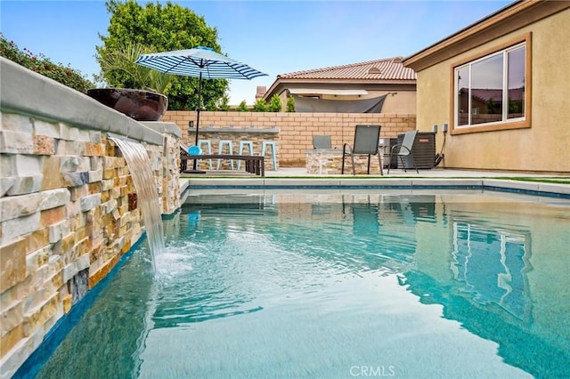 view of swimming pool featuring pool water feature and central air condition unit