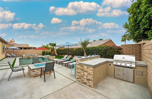 view of patio with exterior bar, an outdoor kitchen, a fire pit, and a grill