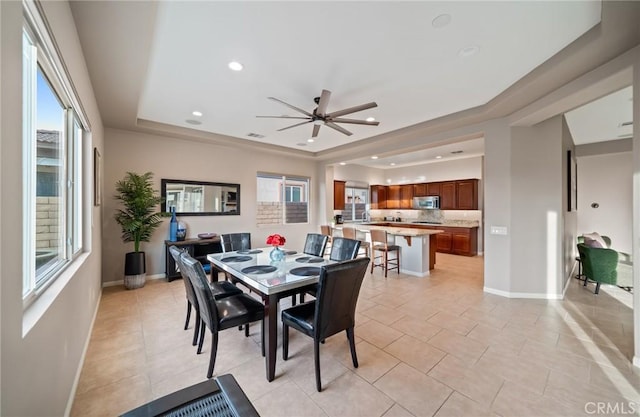 dining space with ceiling fan, light tile patterned flooring, and a wealth of natural light