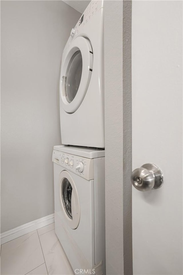 laundry area with stacked washer / drying machine