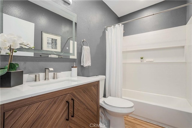 full bathroom featuring vanity, hardwood / wood-style flooring, toilet, and shower / tub combo with curtain